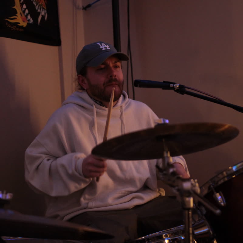 Kevin behind the drum kit during rehearsal