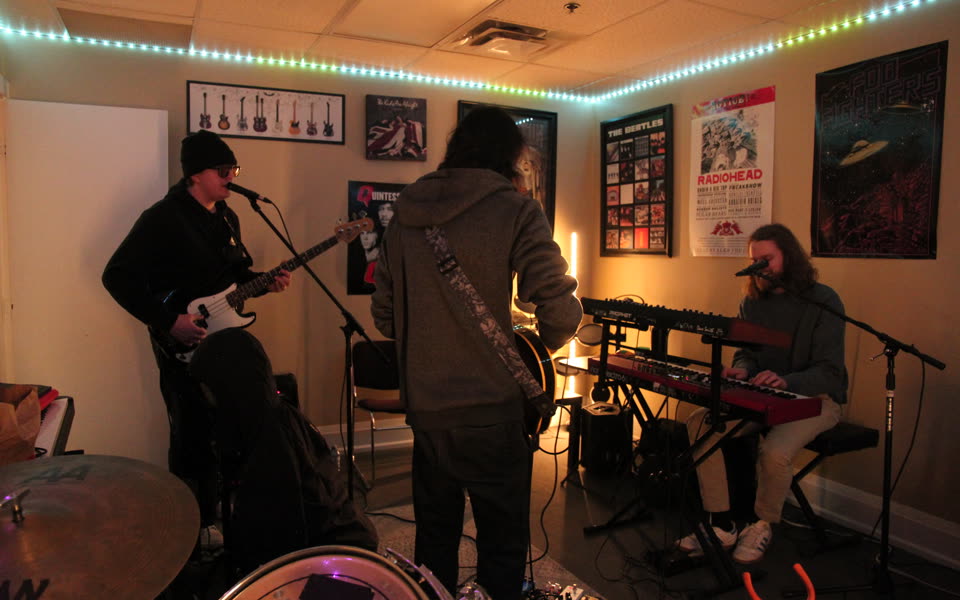 Band recording together during a behind-the-scenes studio session