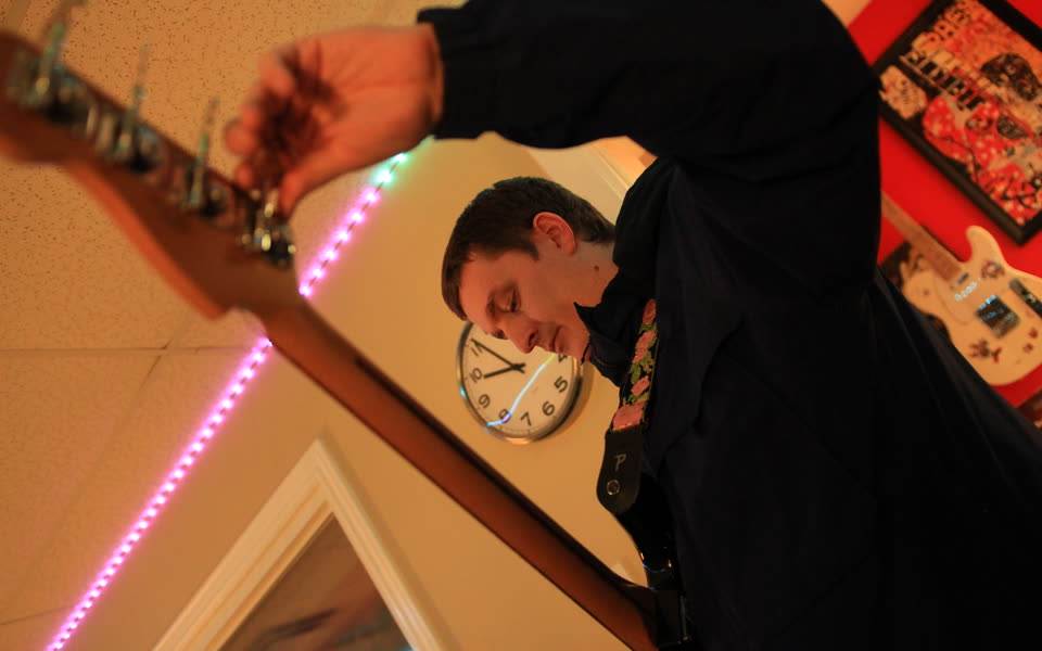 Spencer recording guitar during the BTS session